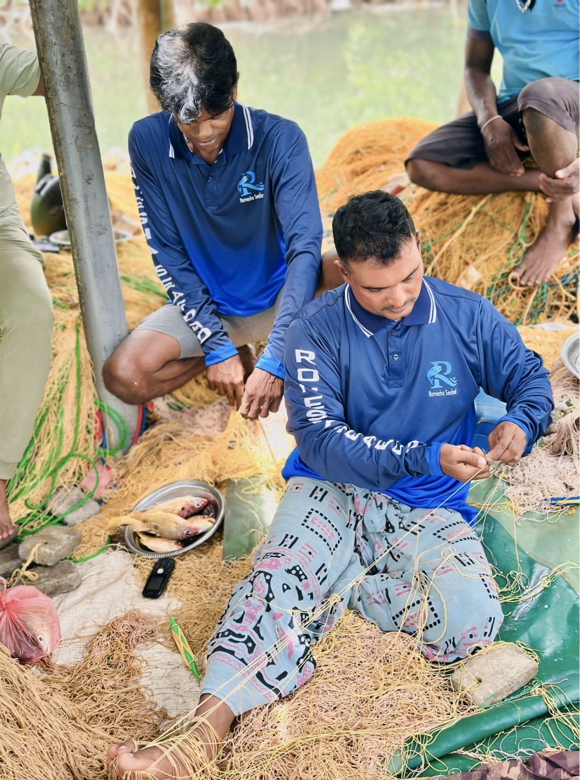 Team working on boat with nets